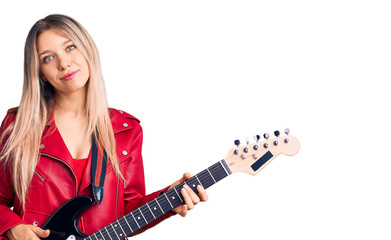 Fototapeta premium Young beautiful blonde woman playing electric guitar thinking attitude and sober expression looking self confident