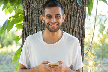 Naklejka na ściany i meble young man using mobile phone outdoors