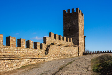 Fototapeta na wymiar The walls of the Genoese fortress in Sudak, Crimea. The tower of Corrado Cigala in the Genoese fortress in Sudak, Crimea.
