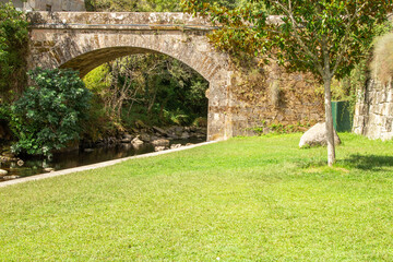 Fototapeta na wymiar old bridge over the bubal river in os peares, ourense, galicia, spain