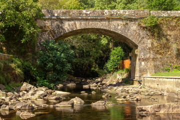 Fototapeta na wymiar old bridge over the bubal river in os peares, ourense, galicia, spain