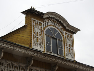 Fototapeta na wymiar Window of a house decorated with wooden carving. Vologda, Russia