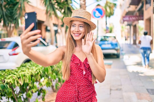 Young caucasian tourist girl smiling happy doing video call using smartphone at the city.