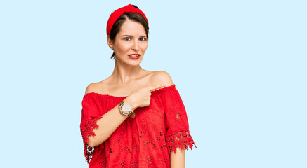 Young brunette woman with short hair wearing casual summer clothes and diadem pointing aside...