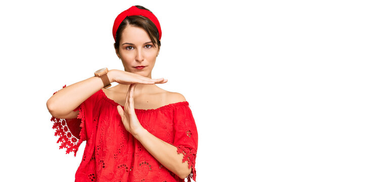 Young brunette woman with short hair wearing casual summer clothes and diadem doing time out gesture with hands, frustrated and serious face