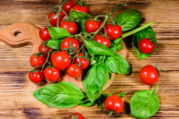 Heap of small cherry tomatoes on wooden table. Top view