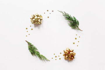 Trendy creatiove Christmas, winter, new year composition. Fir tree branches, golden decorations on beige background. Flat lay, top view, copy space