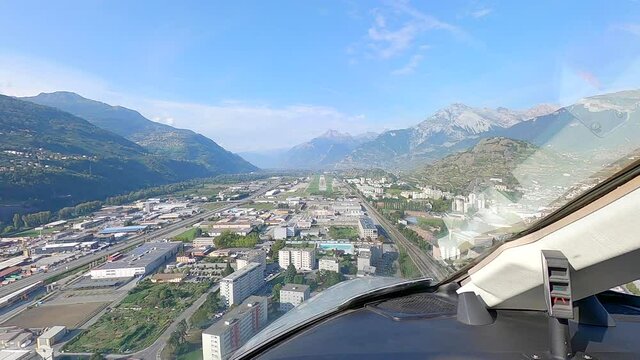 Pilot viewpoint from cockpit, aircraft landing at mountain airport POV