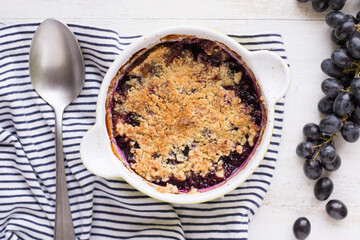 Crumble grape pie on wooden table
