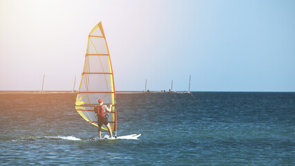 Recreational Water Sports. Windsurfing. Windsurfer Surfing The Wind On Waves In Ocean, Sea. High quality photo
