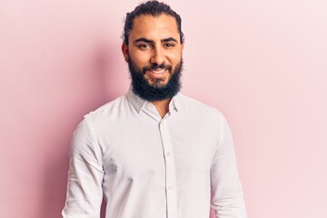 Young arab man wearing casual clothes with a happy and cool smile on face. lucky person.
