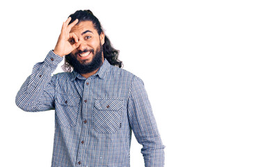 Young arab man wearing casual clothes doing ok gesture with hand smiling, eye looking through fingers with happy face.