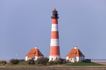Fototapeta na wymiar Westerheversand lighthouse in Schleswig-Holstein, Germany. Considered to be one of the best-known lighthouses in northern Germany, it was built in 1908.