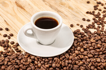 Cup of Espresso Coffee and roasted beans on wooden table background