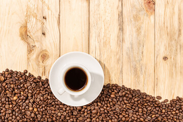 Cup of Espresso Coffee and roasted beans on wooden table background