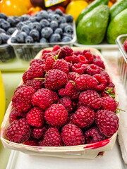 Raspberries are on the counter in the supermarket