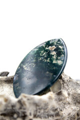 Isolated photo of a moss agate cabochon