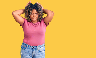 Young african american plus size woman wearing casual clothes doing bunny ears gesture with hands...