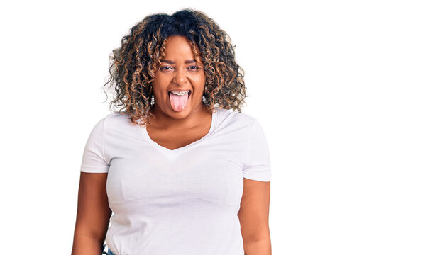 Young african american plus size woman wearing casual clothes sticking tongue out happy with funny expression. emotion concept.