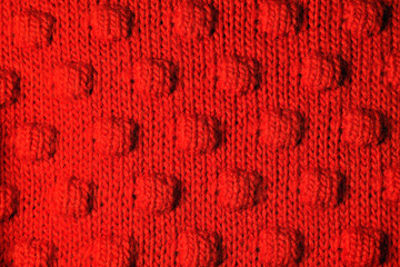 Embossed red woolen background. Warm clothes.