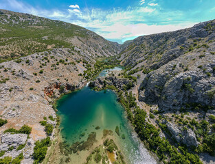 Fototapeta na wymiar Zrmanja River in northern Dalmatia, Croatia is famous for its crystal clear waters and countless waterfalls surrounded by a deep canyon.