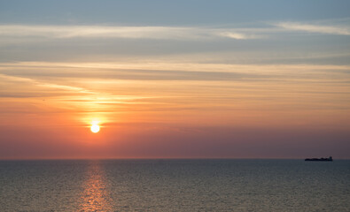 Sunset in the sea on a warm summer evening, seascape.