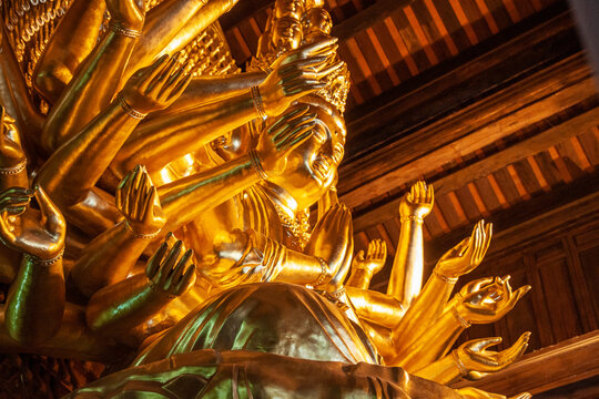 Golden statue of Avalokiteshvara goddess in a buddhist temple, Vietnam