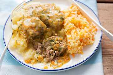 Pork chops in vegetable dill sauce with mashed potatoes nd cabbage slaw 
