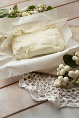 white homemade cheese - traditional milk creamy dairy product on vintage wooden board. Rustic style.