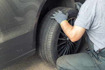 Car wheel repair shop outdoor ground . Seasonal winter tyre change at workshop. Vehicle tire repair, inspection and maintenance. Automotive garage for replace spare parts after failure breakdown