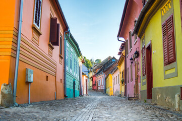 Fototapeta na wymiar Colorful houses on street in Sighisoara, Romania