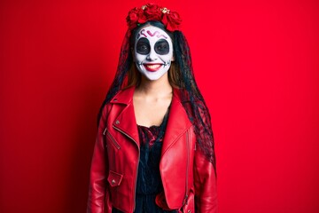 Woman wearing day of the dead costume over red with a happy and cool smile on face. lucky person.