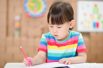 young girl practice drawing different shapes  for homeschooling