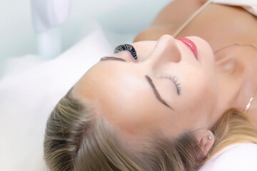 Obraz na płótnie Canvas Eyelash extension procedure. Woman eye with long eyelashes. Close up