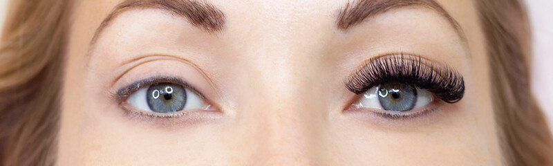 Fototapeta na wymiar Eyelash extension procedure. Woman eye with long eyelashes. Close up