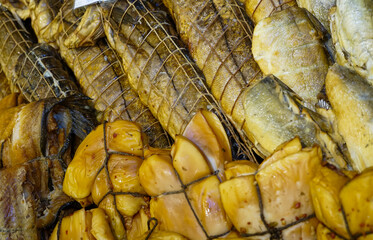 background of golden smoke-dried fish close up