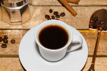 White cup of coffee on rustic wooden background 