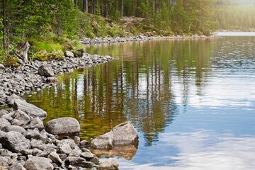 Lofsdalen, Sweden. View of the wooded shore from the Lofssjön lake.