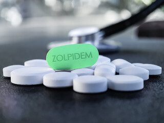 Zolpidem green tablet with stethoscope in background