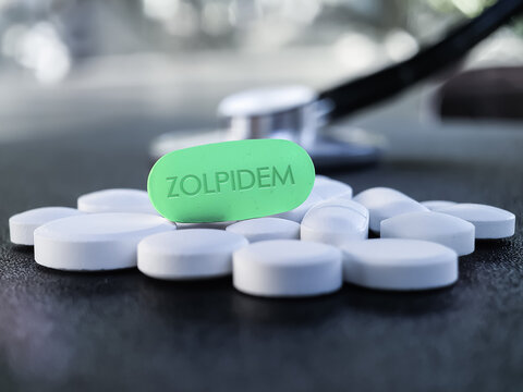 Zolpidem green tablet with stethoscope in background