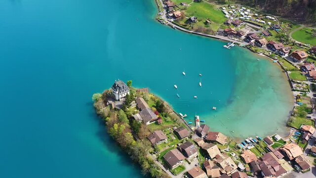 Tilt down aerial footage of the famous Iseltwald peninsula on lake Brienz in Bern canton in Switzerland
