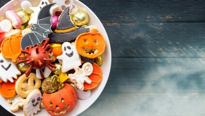 happy halloween card background, Jack o Lantern candy bowl with virus body candy, sweets and halloween cookies Trick or Treat surrounded by festive decor spiders, bats, skull