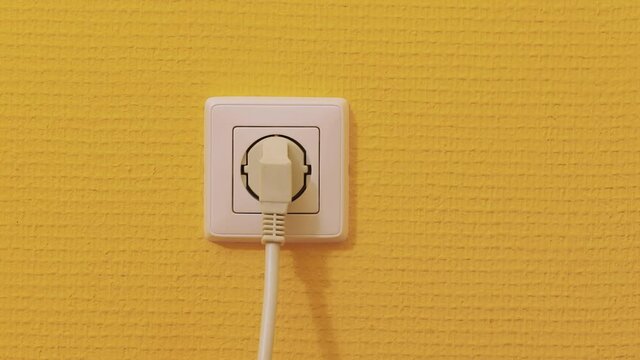 Electric outlet plugging and unplugging a power cord, European Type F