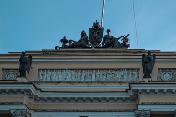 Senate square 1, Saint Petersburg, Russia, 11.10.2020. Constitutional Court of the Russian Federation. Green sculptures of ancient statues sit on roof of white yellow building. Blue sky