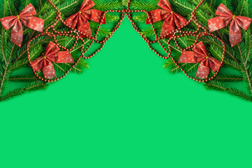 Frame made of Christmas decorations on green background, top view with space for text.