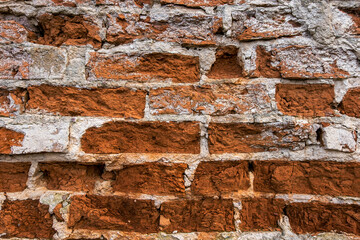 Old brick wall, old texture of red stone blocks close up