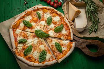 Pizza with cheese and basil leaves
