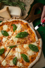 Pizza with cheese and basil leaves
