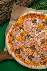 Pizza with cheese, herbs and meat in an Italian pizzeria
