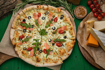 Pizza with cheese and salmon in an Italian pizzeria
